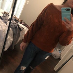 Orange sweater with knit detailing